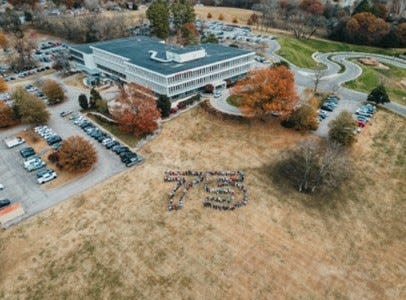 Employees in the Columbia headquarters of Farm Bureau Insurance of Tennessee gathered on the front lawn to form a 75 to commemorate the company’s anniversary.