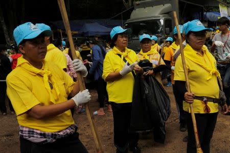 Volunteers clear the campsite of the rescue mission for the 12 boys of the "Wild Boars" soccer team and their coach, near the Tham Luang cave complex, in the northern province of Chiang Rai, Thailand July 14, 2018. REUTERS/Tyrone Siu