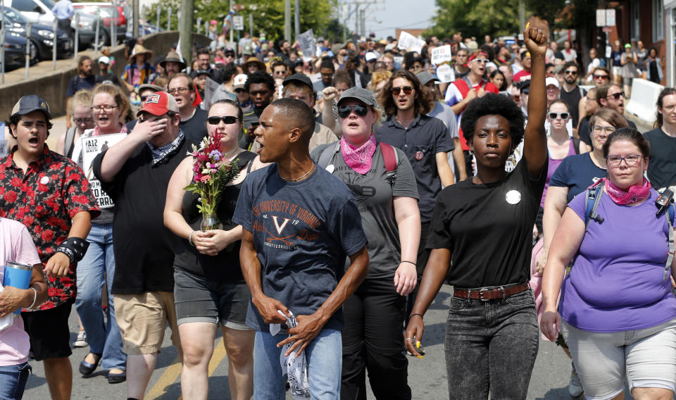 Demonstrators against racism march along city streets as they mark the anniversary of last year's Unite the Right rally in Charlottesville, Va., Sunday, Aug. 12, 2018. (AP Photo/Steve Helber)