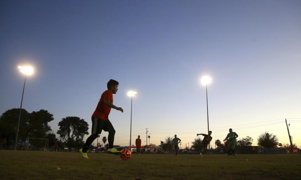 Adelfo Guillermo Martin Perez, 24, an arrival in the United States for three months and originally from Guatemala, dribbles the ball at a Maya Chapin soccer league game Wednesday, April 17, 2019, in Phoenix. (AP Photo/Ross D. Franklin)
