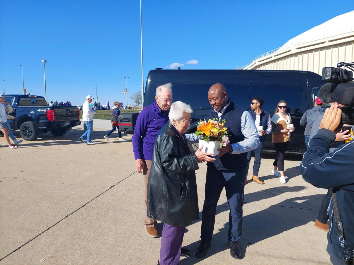 Sen. Tim Scott greets Barbara Grassley and her husband, Sen. Chuck Grassley, with flowers before tailgating outside the University of Northern Iowa football game Saturday, Oct. 21, 2023, in Cedar Falls. Barbara Grassley was celebrating her 91st birthday.