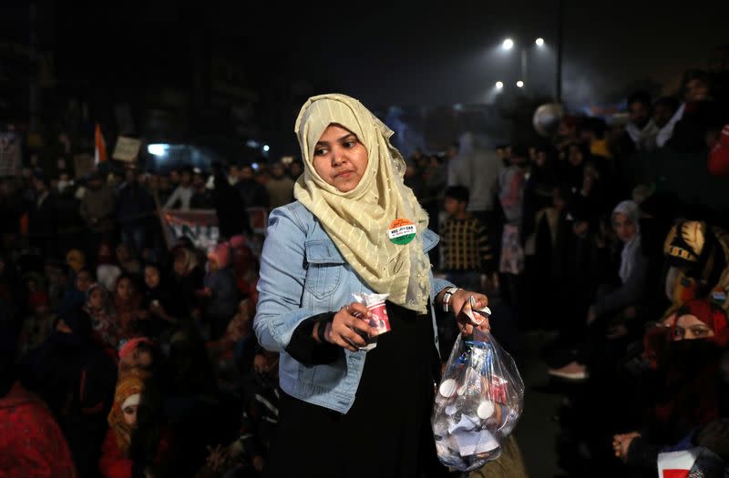 A demonstrator collects garbage during a protest against a new citizenship law, in New Delhi