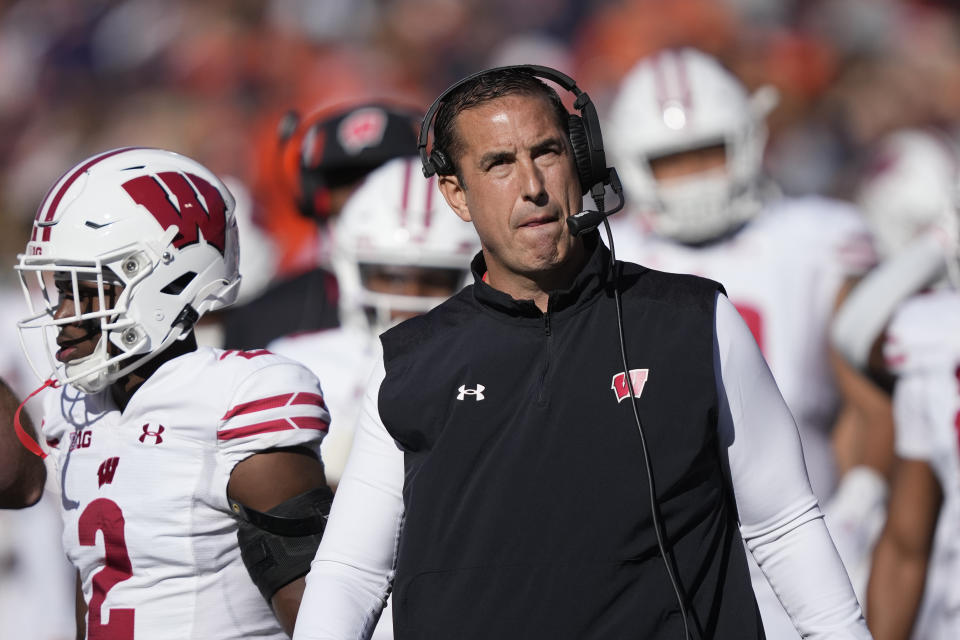 Wisconsin Badgers head coach Luke Fickell looks at the scoreboard during the first half of an NCAA college football game against Illinois, Saturday, Oct. 21, 2023, in Champaign, Ill. (AP Photo/Charles Rex Arbogast)