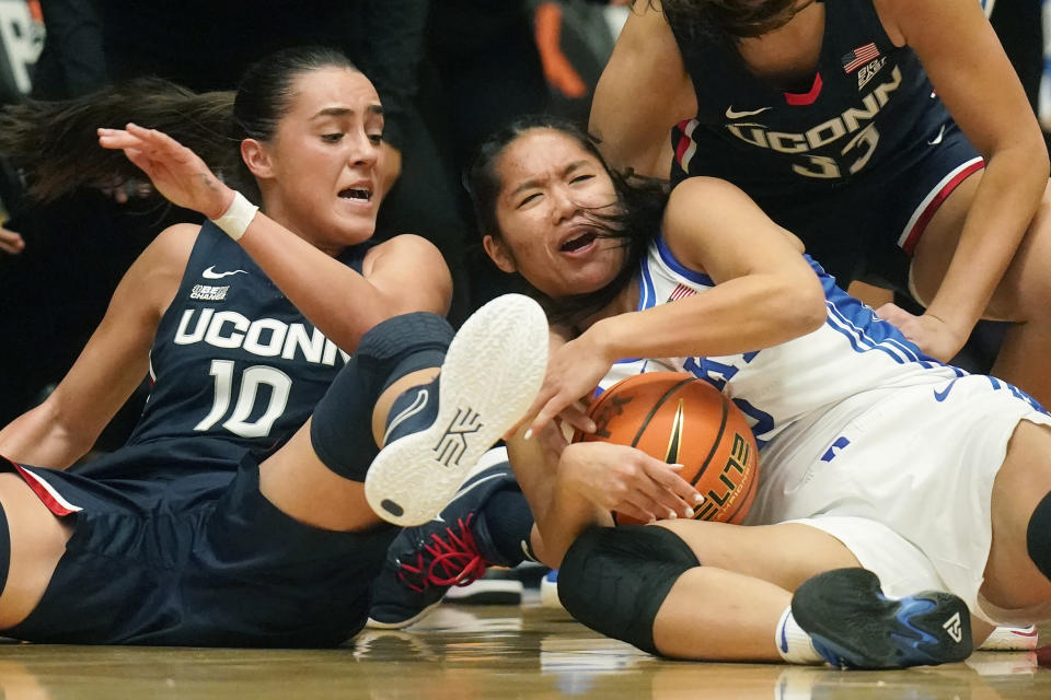 Duke guard Vanessa de Jesus, right, battles for the ball against Connecticut's Nika Muhl (10) during the first half of an NCAA college basketball game in the Phil Knight Legacy tournament Friday, Nov. 25, 2022, in Portland, Ore. (AP Photo/Rick Bowmer)