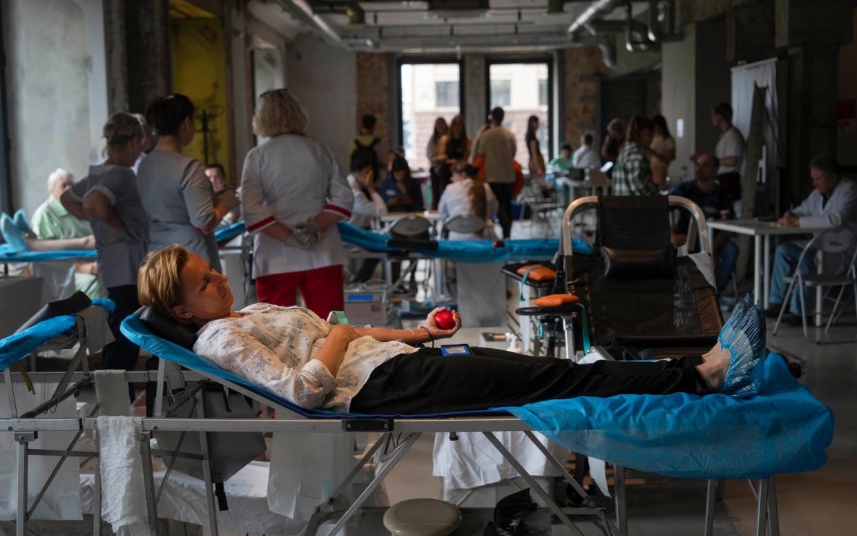 Volunteers donate blood for the army in the art space of a book shop in Kyiv,