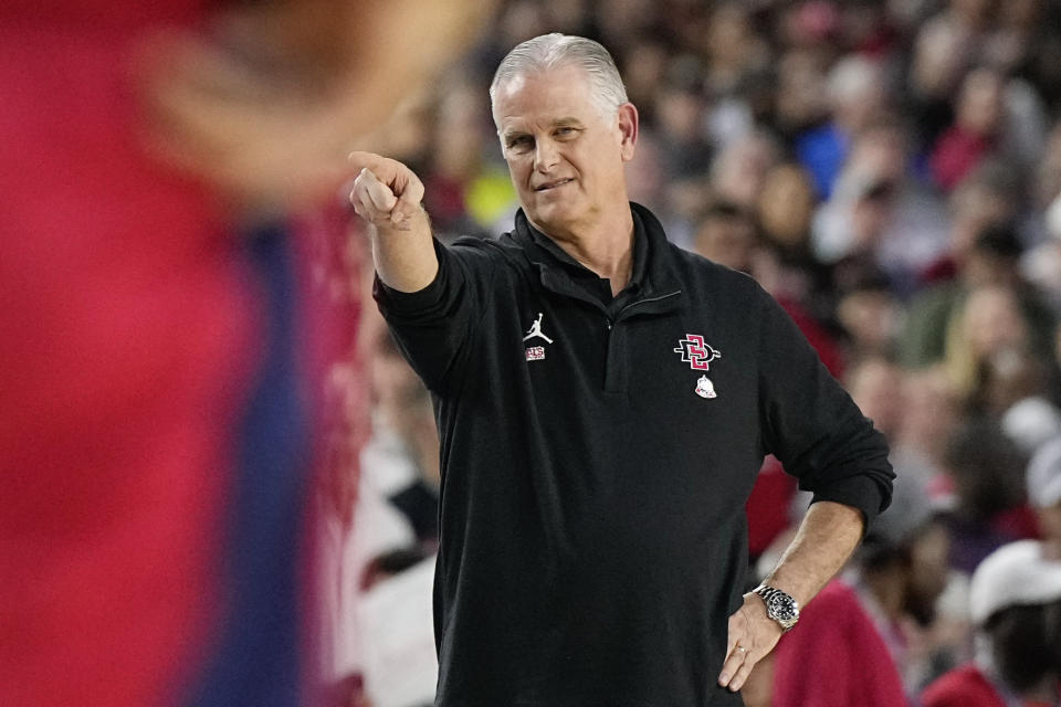 San Diego State head coach Brian Dutcher points during the first half of a Final Four college basketball game against Florida Atlantic in the NCAA Tournament on Saturday, April 1, 2023, in Houston. (AP Photo/Brynn Anderson)
