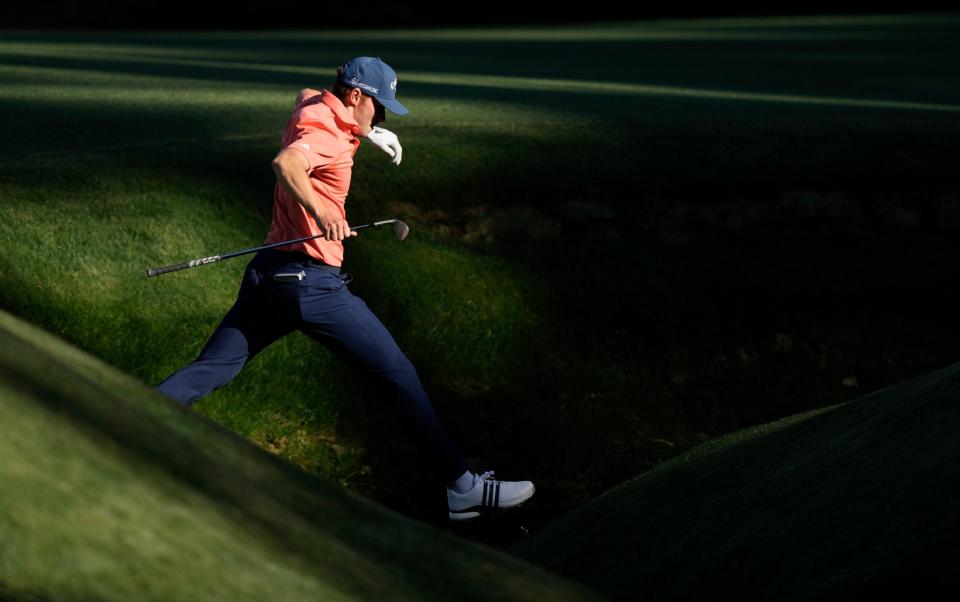 Nicolai Hojgaard hopping over the creek on the 13th