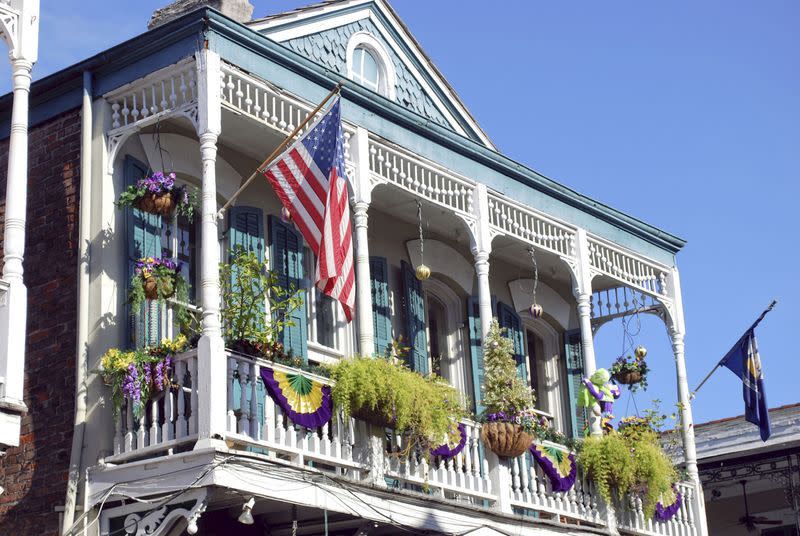 house in new orleans with balcony decorated for mardi gras