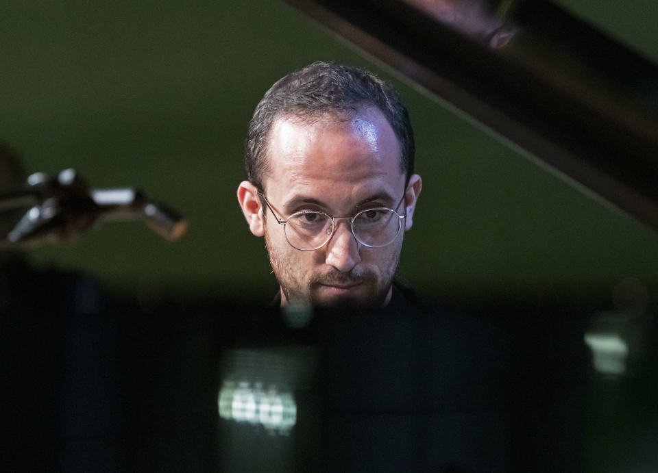 FILE - Russian-German pianist Igor Levit performs at the Green party convention in Leipzig, Germany on Nov. 9, 2018. Levit will perform Shostakovich’s 24 “Preludes and Fugues" at Carnegie Hall on Tuesday night, part of a quick U.S. tour that takes him to the Kennedy Center in Washington, D.C., on Thursday and Clayton State University in Morrow, Georgia, on Sunday. (AP Photo/Jens Meyer, File)