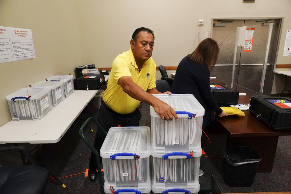 Cameron County Department of Elections early voting clerk Francisco Rodriguez unpacks sealed boxes of blank ballots Friday, Oct. 28, 2022, ahead of the day's opening of the early voting polling location for the Texas midterm elections in Harlingen, Texas.(Denise Cathey/The Brownsville Herald via AP)