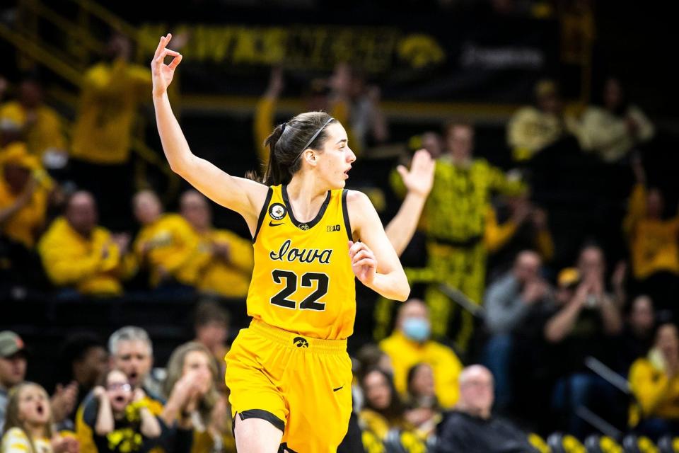 Iowa guard Caitlin Clark (22) reacts after making a 3-point basket during a 2022 game against Ohio State at Carver-Hawkeye Arena.