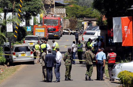 Kenyan policemen and explosives experts gather evidence from the car suspected to have been used by the attackers outside the scene where explosions and gunshots were heard at The DusitD2 complex, in Nairobi, Kenya January 17, 2019. REUTERS/Njeri Mwangi