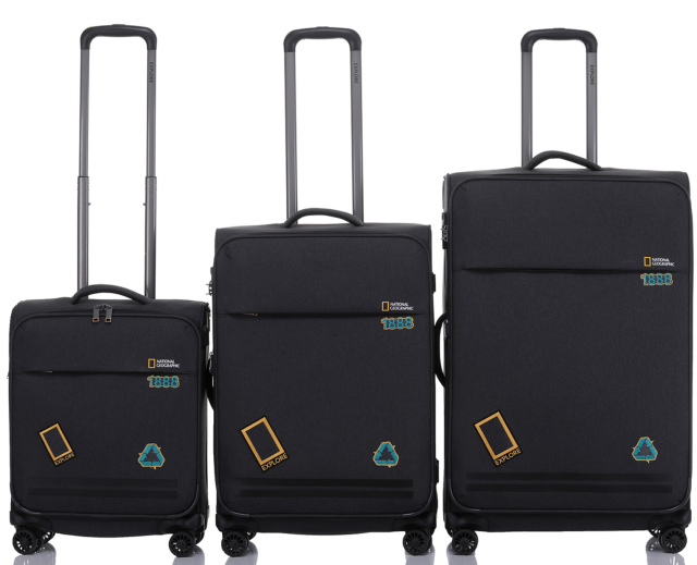 A set of 3 black National Geographic suit cases with trolley handles extended on a white background