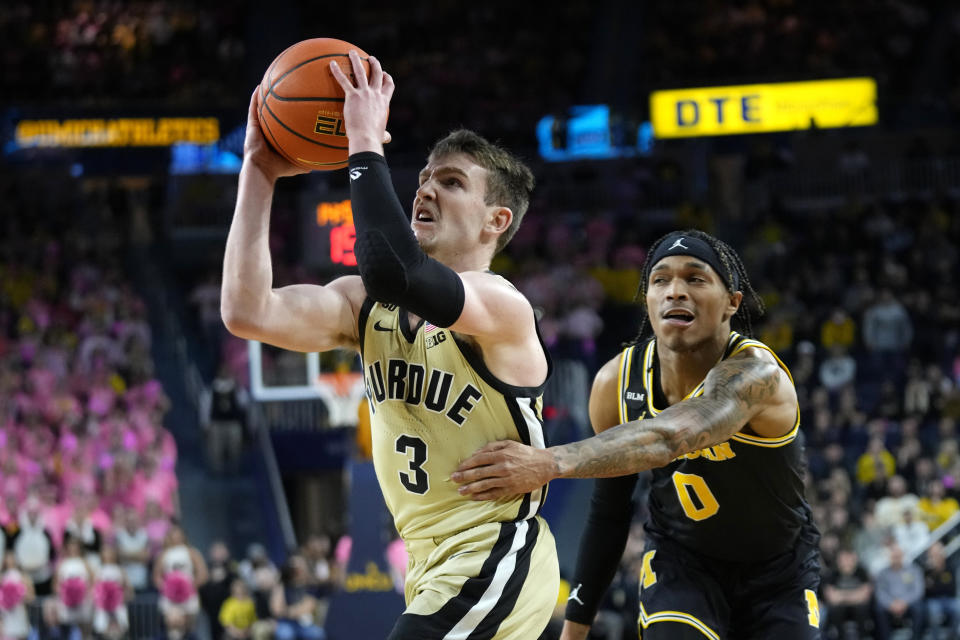 Purdue guard Braden Smith (3) drives to the basket past Michigan guard Dug McDaniel (0) during the first half of an NCAA college basketball game in Ann Arbor, Mich., Thursday, Jan. 26, 2023. (AP Photo/Paul Sancya)