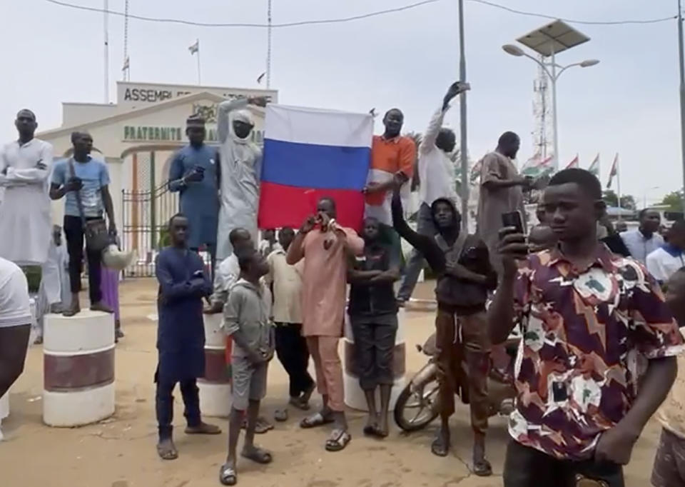 Supporters of mutinous soldiers hold up a Russian flag as they demonstrate in Niamey, Niger, Thursday July 27 2023. Governing bodies in Africa condemned what they characterized as a coup attempt Wednesday against Niger's President Mohamed Bazoum, after members of the presidential guard declared they had seized power in a coup over the West African country's deteriorating security situation. (AP Photo/Sam Mednick)