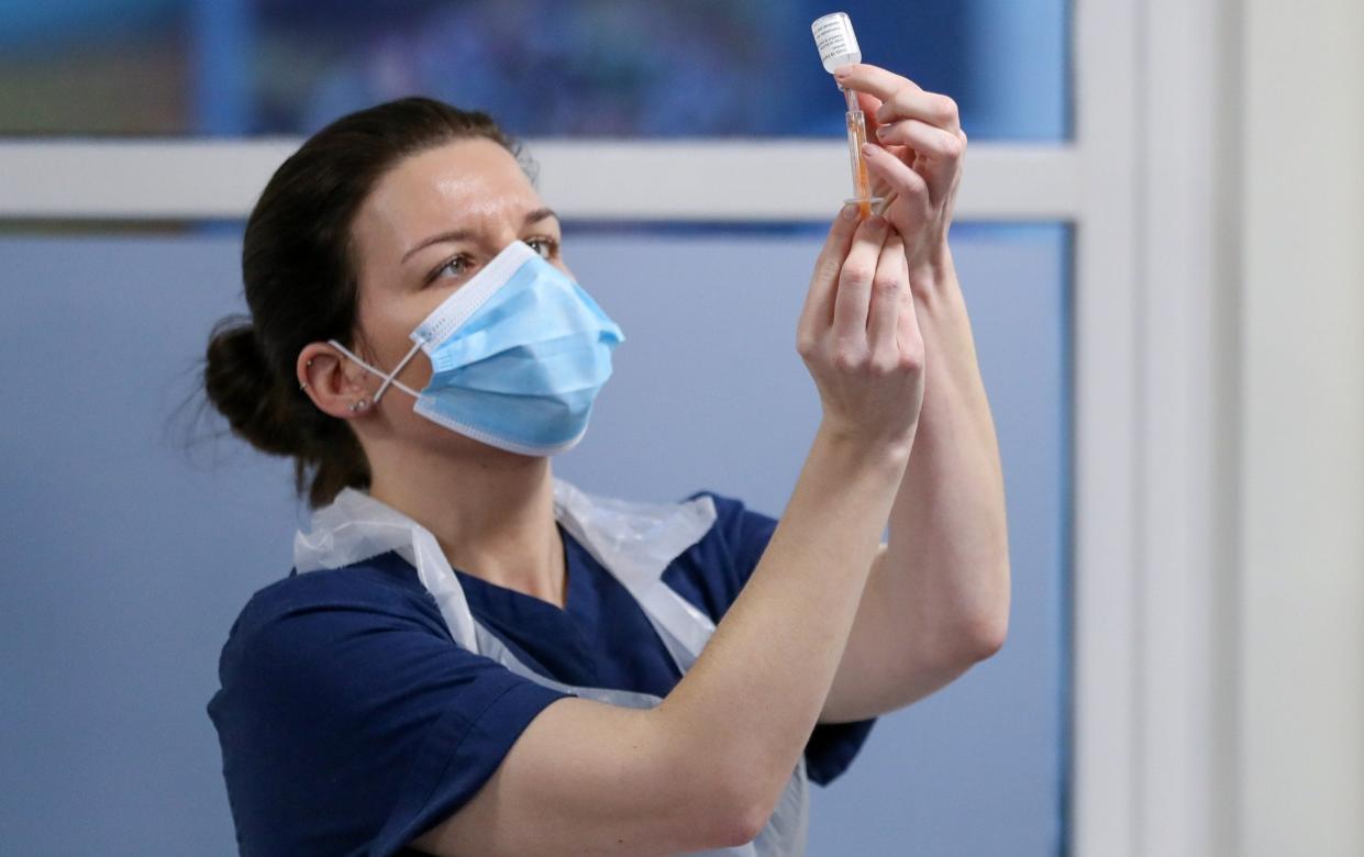 Marianne Stewart, a practice nurse, fills a syringe with a dose of AstraZeneca coronavirus disease (COVID-19) vaccine at the Pentland Medical Practice, in Currie, Scotland, Britain J - Reuters