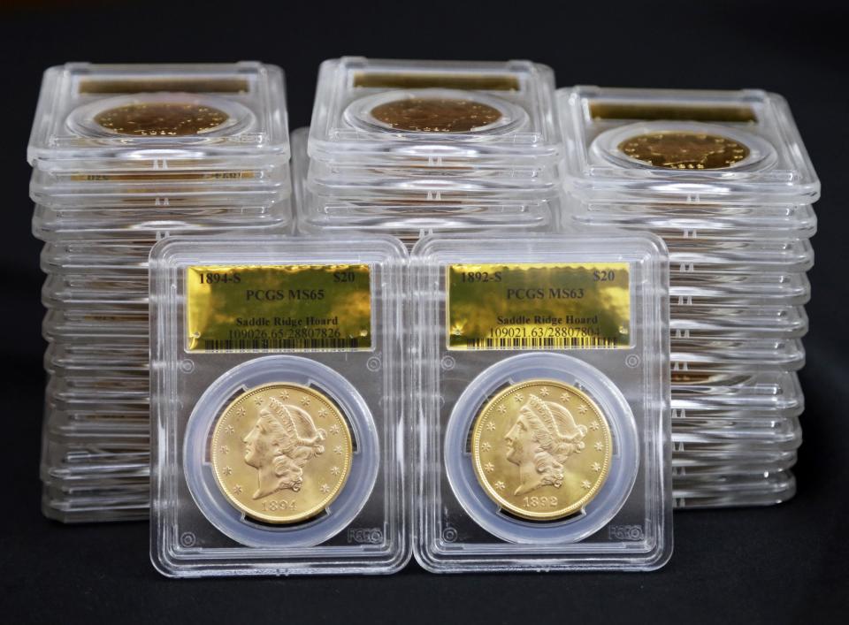 Some of 1,427 Gold-Rush era U.S. gold coins are displayed at Professional Coin Grading Service in Santa Ana, Calif., Tuesday, Feb. 25, 2014. A California couple out walking their dog on their property stumbled across the modern-day bonanza: $10 million in rare, mint-condition gold coins buried in the shadow of an old tree. Nearly all of the 1,427 coins, dating from 1847 to 1894, are in uncirculated, mint condition, said David Hall, co-founder of Professional Coin Grading Service, who recently authenticated them. Although the face value of the gold pieces only adds up to about $27,000, some of them are so rare that coin experts say they could fetch nearly $1 million apiece. (AP Photo/Reed Saxon)