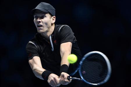 Tomas Berdych of the Czech Republic hits a return to Rafael Nadal of Spain during their men's singles tennis match at the ATP World Tour Finals at the O2 Arena in London November 8, 2013. REUTERS/Dylan Martinez