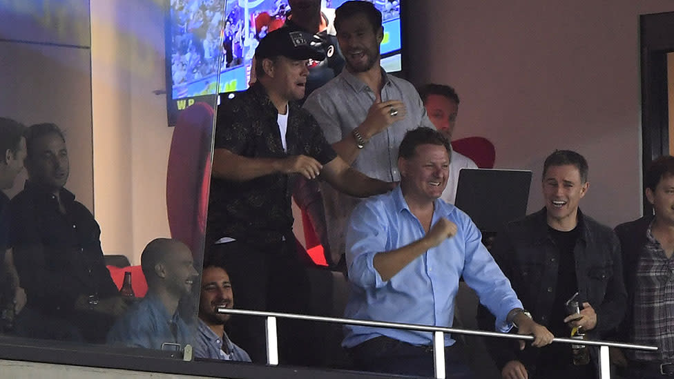 Chris Hemsworth brought Matt Damon along to an AFL game last night. Photo: AAP