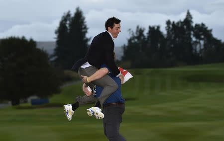 Team Europe golfer Rory McIlroy is lifted up by a colleague after the closing ceremony of the 40th Ryder Cup at Gleneagles in Scotland September 28, 2014. REUTERS/Toby Melville