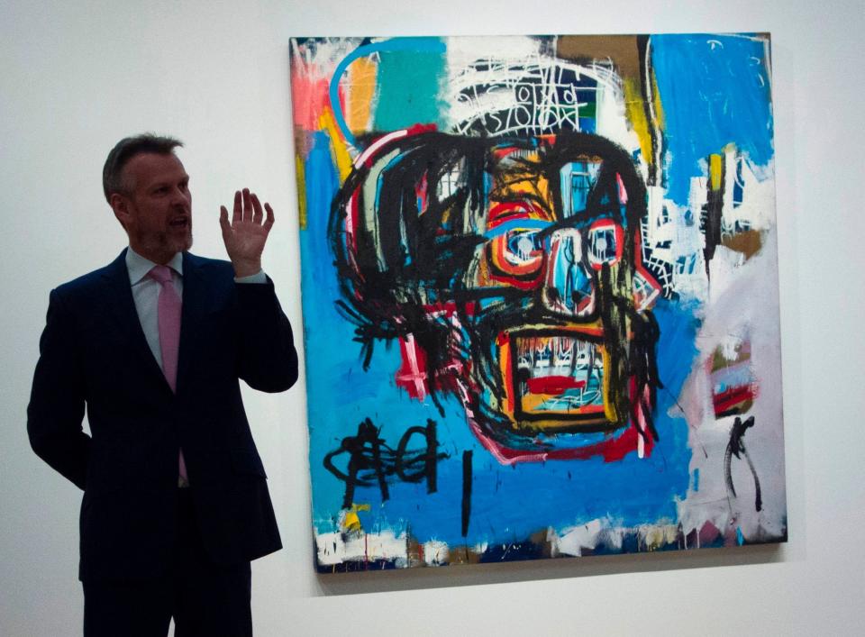 A Sotheby's official speaks about an untitled painting by Jean-Michel Basquiat during a media preview May 5, 2017 at Sotheby's In New York.&nbsp; (Photo: DON EMMERT via Getty Images)