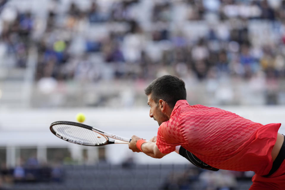 Serbia's Novak Djokovic returns the ball to Argentina's Tomas Etcheverry during their match at the Italian Open tennis tournament, in Rome, Friday, May 12, 2023. (AP Photo/Andrew Medichini)