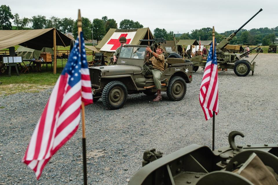 A re-enactor steps out of a vintage war-era Jeep, Friday, Sept. 8 during the annual Steam to Victory event at the Age of Steam Roundhouse Museum in Sugarcreek.