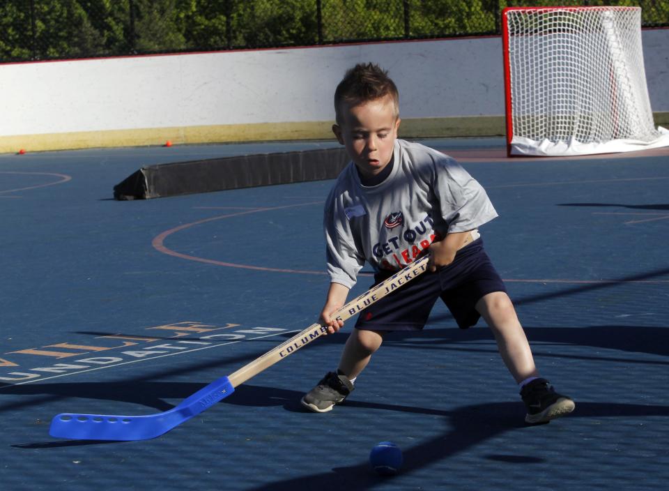 Brayden Hafer, 4, works on his ball-handling skills during the Blue Jackets' Get Out And Learn street-hockey session at Thomas Knox Rink May 9.