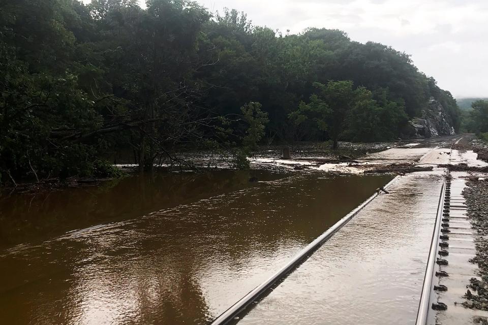 Water flows over the Metro North train tracks along the Hudson River during a flash flood