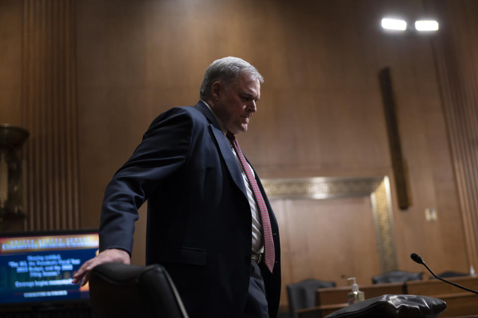 FILE - Internal Revenue Service Commissioner Charles Rettig prepares to testify before the Senate Finance Committee, at the Capitol in Washington, April 7, 2022. A new report from the National Taxpayer Advocate says that taxpayers are experiencing longer wait times on the phone, there’s an even bigger backlog of paper returns than there was a year ago, and delays in processing paper returns have been running six months to one year. (AP Photo/J. Scott Applewhite, File)