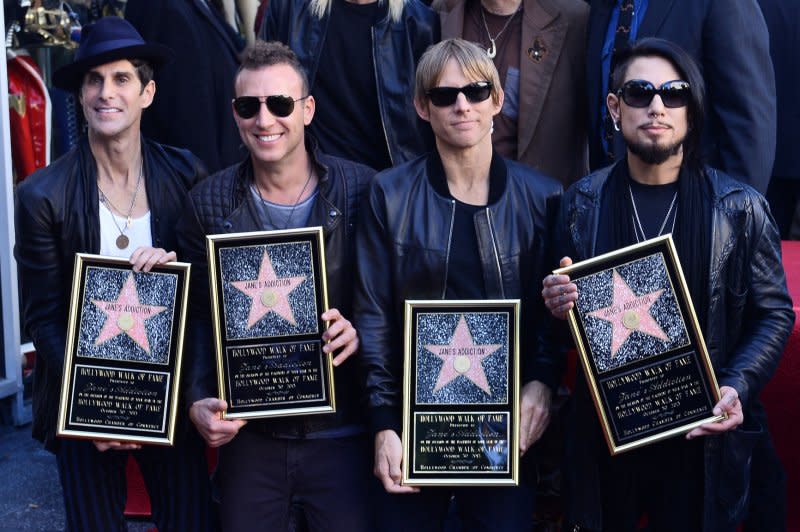 Left to right, members of Jane's Addiction, Perry Farrell, Stephen Perkins, Chris Chaney, and Dave Navarro hold replica plaques during an unveiling ceremony honoring the group with the 2,509th star on the Hollywood Walk of Fame in Los Angeles in 2013. File Photo by Jim Ruymen/UPI