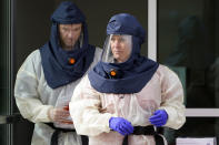 FILE - In this Friday, Oct. 23, 2020 file photo, Salt Lake County Health Department public health nurses look on during coronavirus testing outside the Salt Lake County Health Department in Salt Lake City. Utah Gov. Gary Herbert and health officials issued repeated pleas for social distancing and mask usage on Thursday, Oct. 29, 2020, as hospitals grow closer to implementing crisis care protocols amid a record-breaking coronavirus surge. (AP Photo/Rick Bowmer, File)