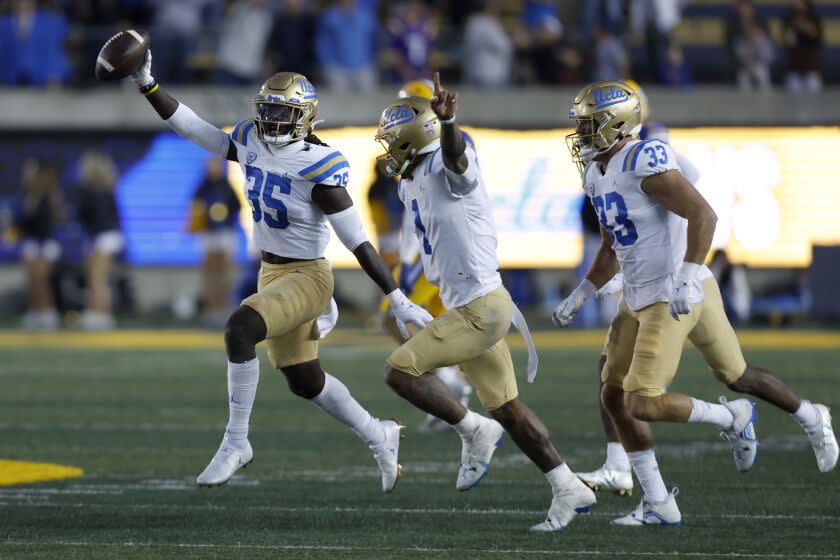 UCLA linebacker Carl Jones Jr. (35) celebrates after he recovered a California fumble to seal the Bruins' win Nov. 25, 2022.