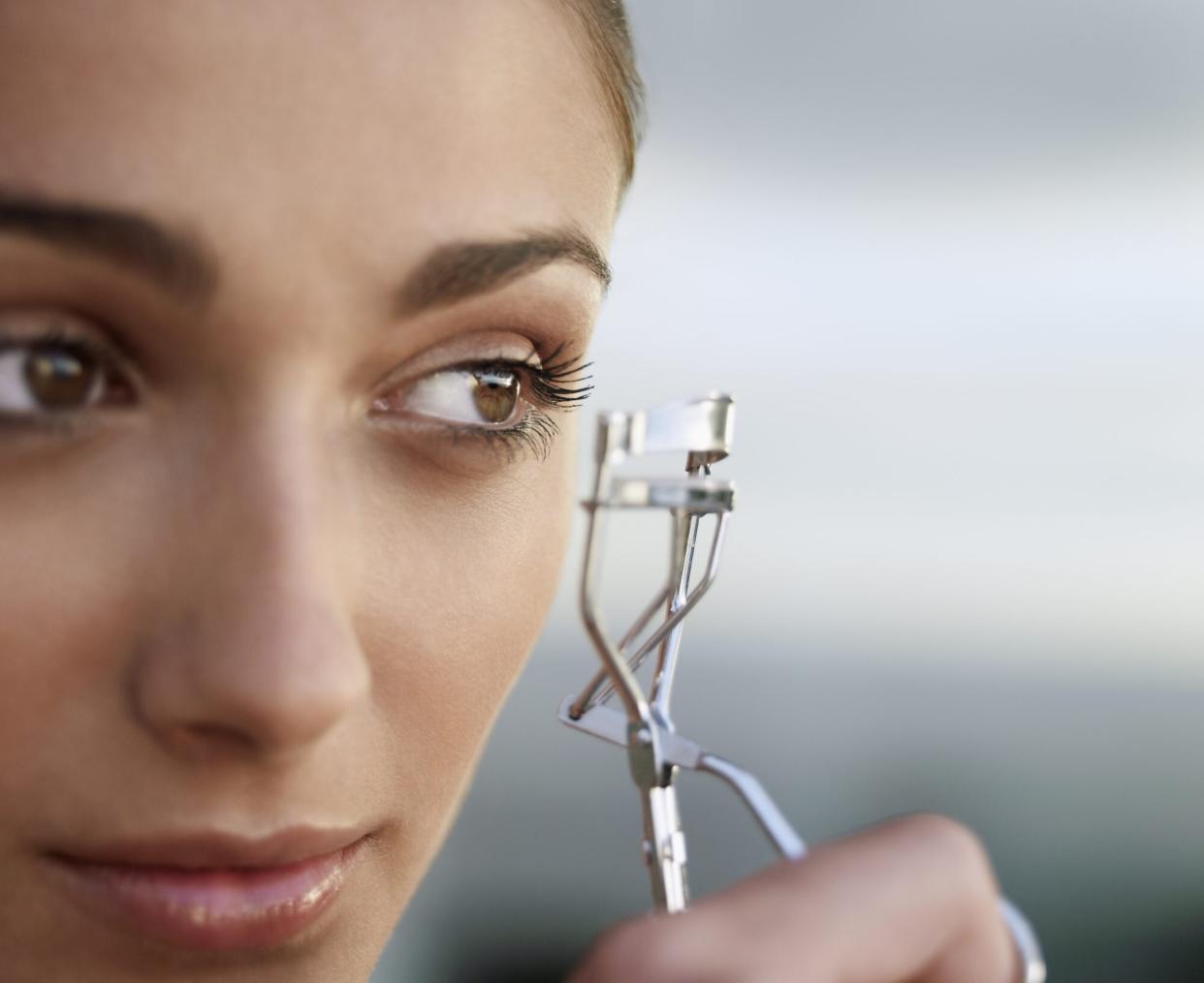 Woman Using an Eyelash Curler