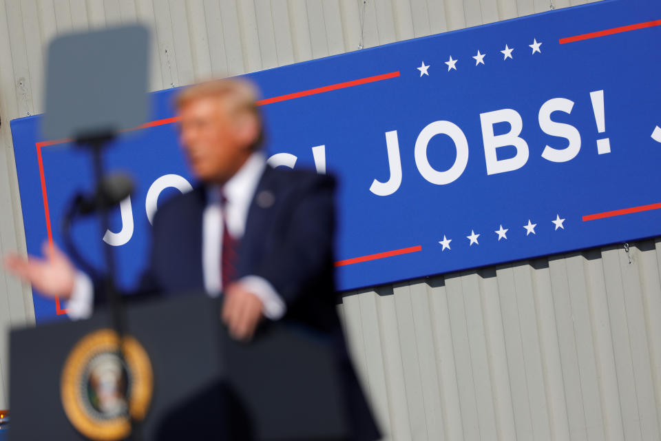 U.S. President Donald Trump speaks in front of a "JOBS! JOBS! JOBS!" banner at a Trump re-election campaign event at Mariotti Building Products in Old Forge, Pennsylvania, U.S., August 20, 2020. REUTERS/Tom Brenner