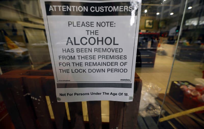 A sign is seen in the window of a closed liquor store during a nationwide lockdown due to the outbreak of the coronavirus disease (COVID-19), in Cape Town