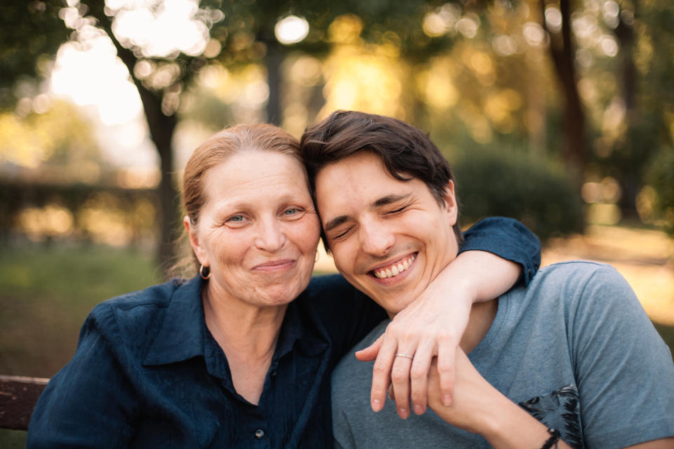 older mother and son embracing and laughing