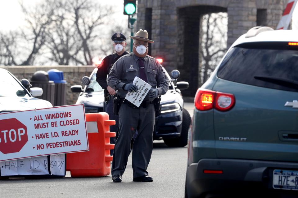Police officers direct drivers as they enter Glen Island Park in New Rochelle, N.Y March 22, 2020. The park was the first site set in Westchester County set up for Covid-19 testing. New Rochelle was the epicenter of the spread of the Covid-19 virus after congregants of a neighborhood synagogue were the first to be diagnosed with the virus. 