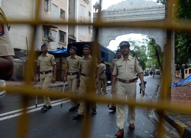 Indian police patrol a road leading to former residence of Yakub Memon, a key plotter of the Mumbai bomb attacks in 1993, in Mumbai on July 30, 2015