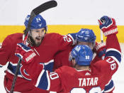 Montreal Canadiens' Brendan Gallagher (11) celebrates with Phillip Danault (24) and Tomas Tatar (90) after scoring against the Winnipeg Jets during the second period of an NHL hockey game Saturday, March 6, 2021, in Montreal. (Graham Hughes/The Canadian Press vIa AP)