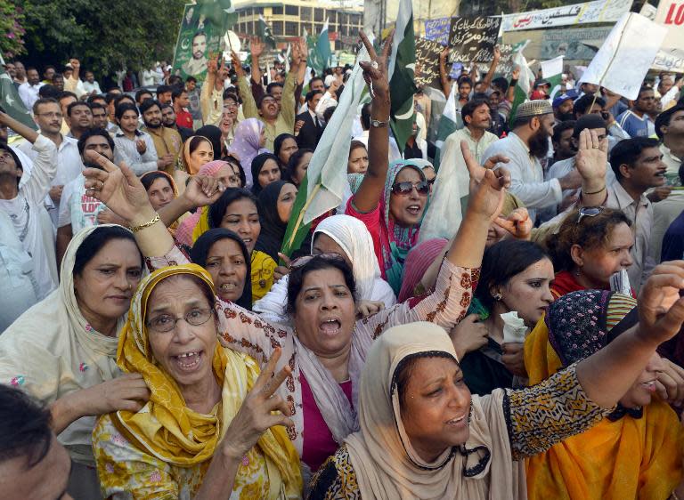 Pakistani supporters of ruling party Pakistan Muslim League-Nawaz (PML-N) chant slogans during a protest against cleric Tahir-ul-Qadri and opposition leader Imran Khan in Lahore on August 11, 2014