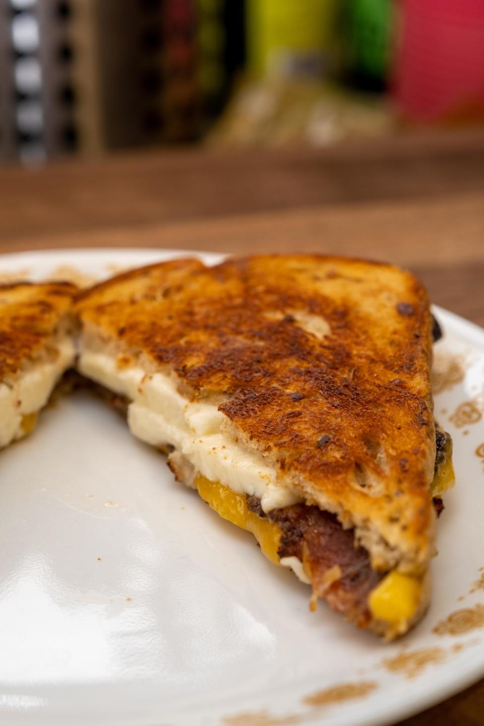 Grilled cheese sandwich cut in half with melted cheese on a plate