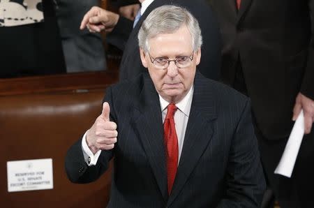 U.S. Senate Majority Leader Mitch McConnell (R-KY) gestures to to a colleague before the start of Japanese Prime Minister Shinzo Abe's address a joint meeting of the U.S. Congress on Capitol Hill in Washington, April 29, 2015. REUTERS/Jonathan Ernst