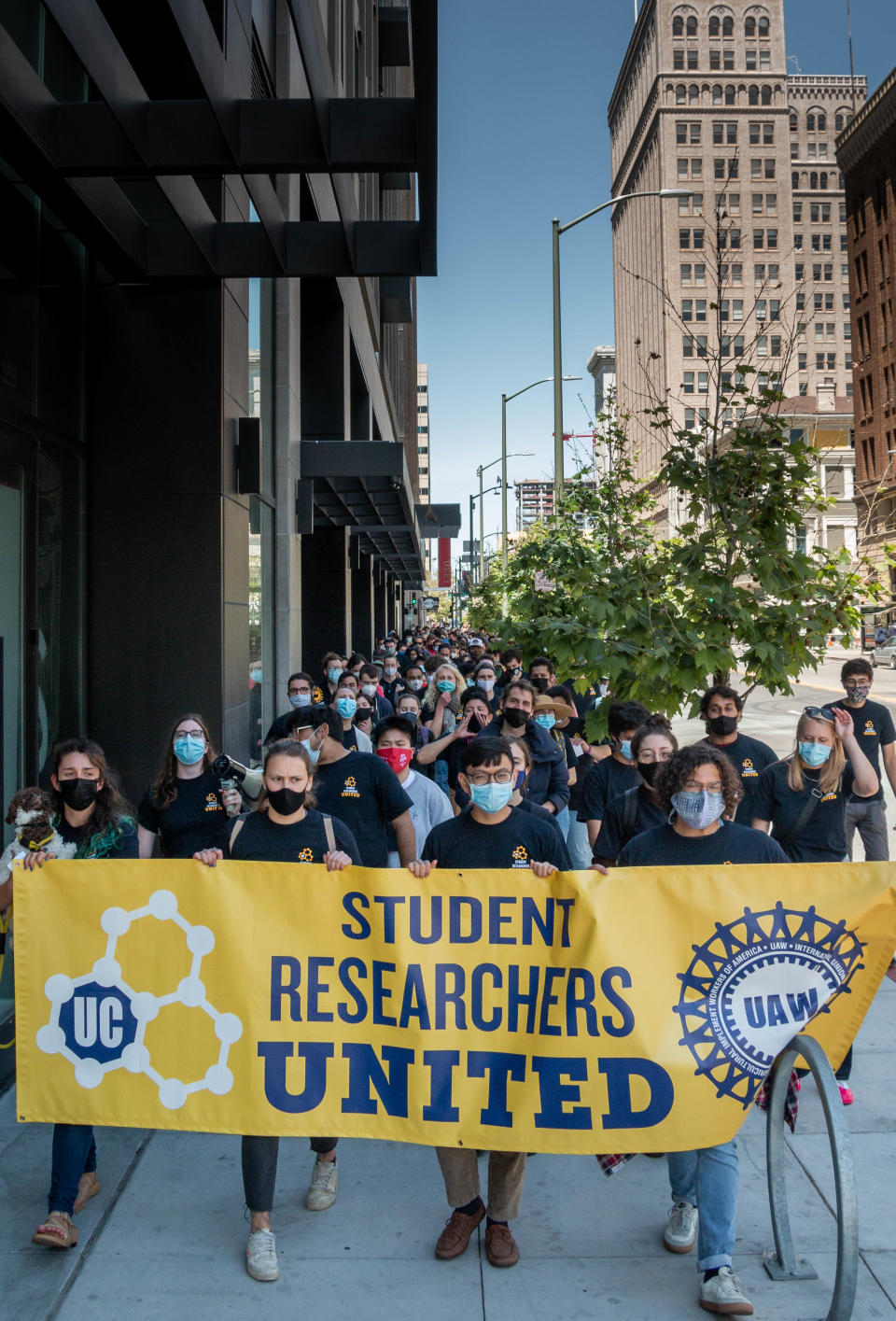 UC student researchers march to drop off their signed union cards at the UAW office.