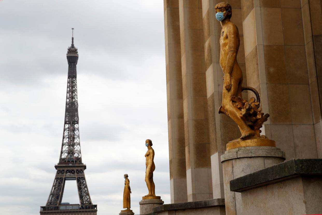 Statues wear masks along Trocadero Square close to the Eiffel Tower in Paris, France on Monday, May 4, 2020. France continues to be under an extended stay-at-home order until May 11 in an attempt to slow the spread of the COVID-19 pandemic.