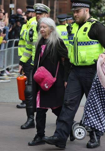 <p>Neil Mockford/GC Images</p> A protester is led away after Just Stop Oil tried to disrupt the wedding celebrations of the Duke of Westminster and Oliva Henson in Chester, U.K. on June 7, 2024.