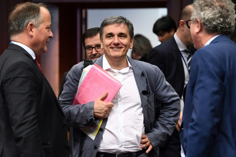 Greece's Finance Minister Euclid Tsakalotos (C), pictured on May 22, 2017, says he is "confident" that the eurozone meeting will reach a "good solution"