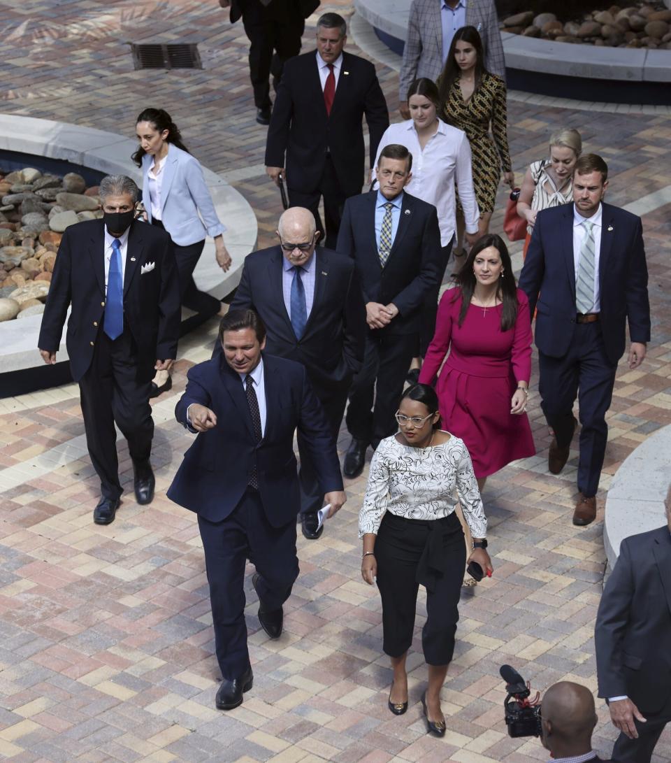 Florida Gov. Ron DeSantis gestures as he is greeted at the MARC building on Florida International University's Miami campus, on Monday, May 24, 2021. DeSantis signed a bill on Monday that seeks to punish social media platforms that remove conservative ideas from their sites. (Carl Juste/Miami Herald via AP)