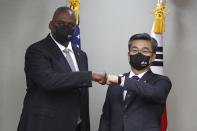 U.S. Secretary of Defense Lloyd Austin, left, bumps elbows with South Korean Defense Minister Suh Wook prior the 53rd Security Consultative Meeting a​t the Ministry of National Defense in Seoul, South Korea, Thursday, Dec. 2, 2021. (Jeon Heon-kyun/Pool Photo via AP)