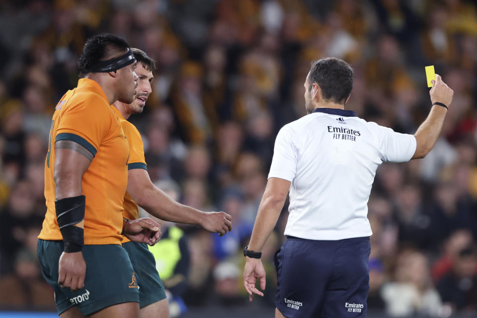 Referee Mathieu Raynal, right, shows Australia's Jake Gordon, second left, a yellow card during their Bledisloe Cup rugby test match against New Zealand in Melbourne, Australia, Thursday, Sept 15, 2022. (AP Photo/Asanka Brendon Ratnayake)